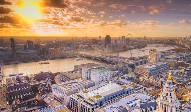 Sunset over rooftops and river Thames